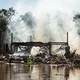 Emergency workers try to douse the smoldering remains of a banquet hall fire after the remnants of Hurricane Ida and its torrential rains tore through the area, in Manville, N.J., Sept. 3, 2021.