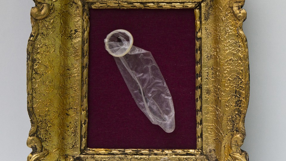 A condom is framed in a golden frame