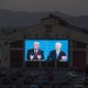 People watch the final U.S. presidential debate between Donald Trump and Joe Biden outside a theater