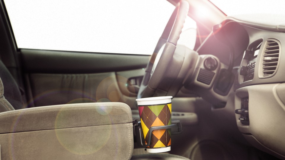 An argyle-patterned cup in a center-console cupholder
