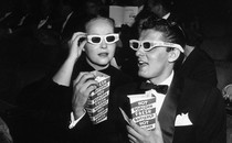 Two moviegoers wearing 3D glasses