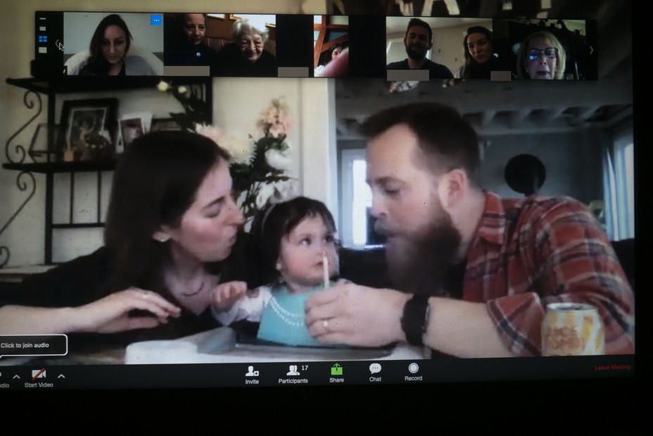 family with baby and 1st birthday candle