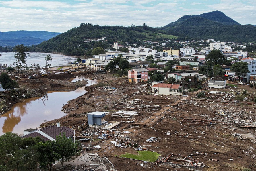 An aerial view of a flood-damaged neighborhood with many buildings entirely wiped away