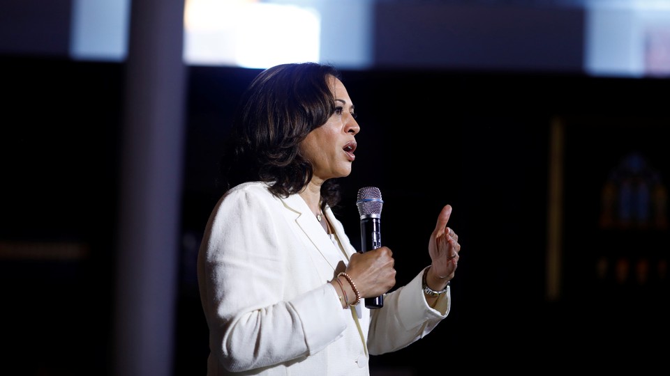 Kamala Harris speaks into a microphone.