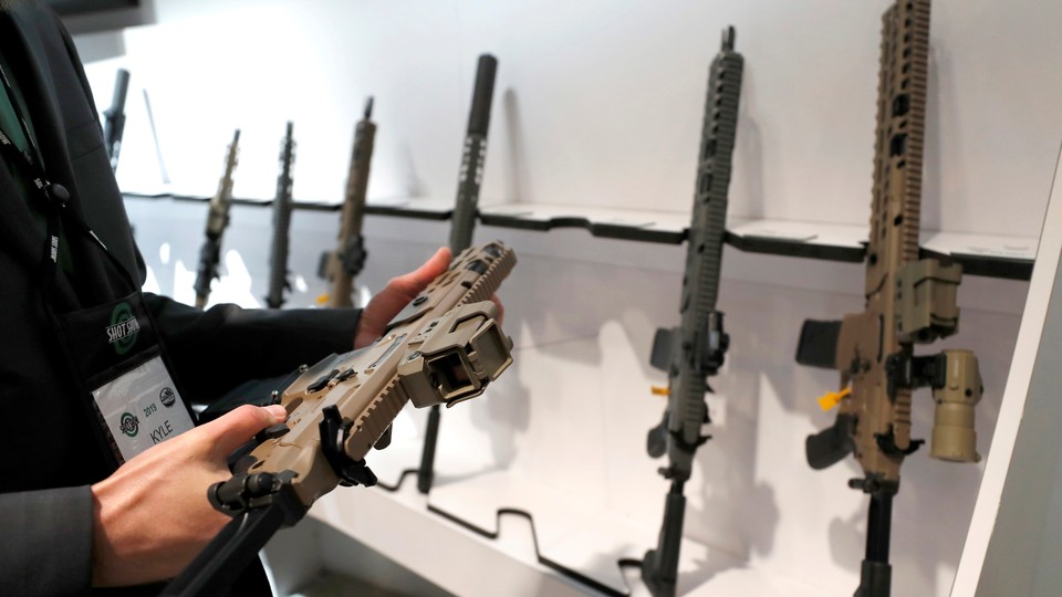 A man looks at a semi-automatic rifle during a gun show in Las Vegas.