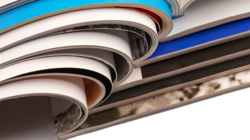 Stack of magazines on white background with reflection