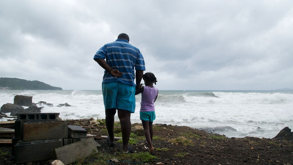 A man and a girl looking at the horizon as a storm approached