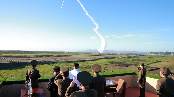 North Korean leader Kim Jong Un watches the test of a new-type anti-aircraft guided weapon system.