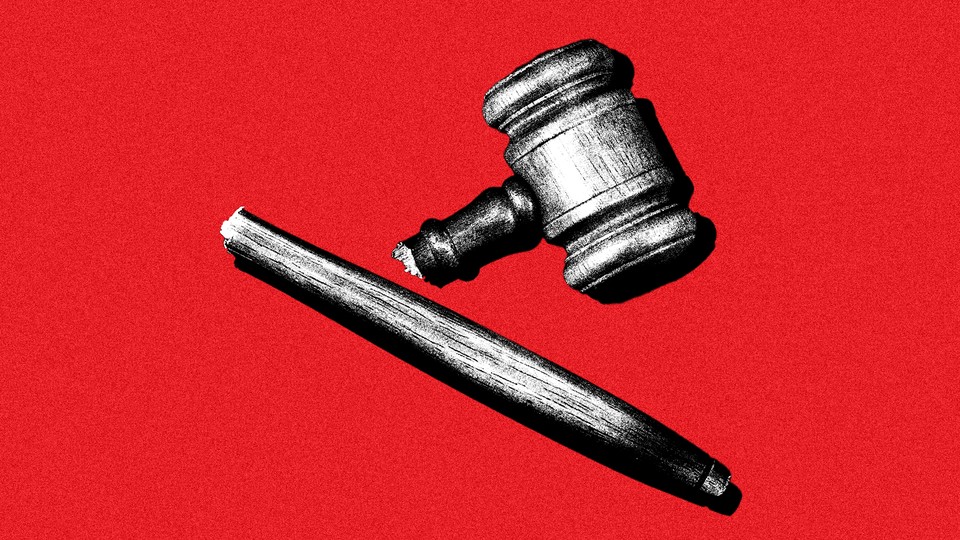 A broken gavel on a red background