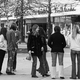 black and white photo of young people hanging out outside stores