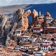 A couple of dozen medium-to-small buildings sit clustered on the slopes of steep rock formations and arches.