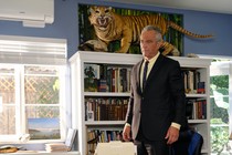Picture of Robert F. Kennedy Jr standing near a desk and a full bookshelf in his office in Los Angeles