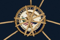 Photo-illustration showing the seal of Department of Justice tied by ropes