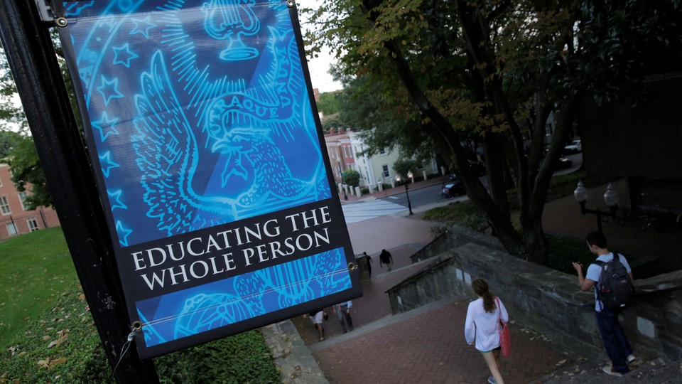 A sign on the Georgetown University campus reads "The Spirit of Georgetown: Education the whole person"