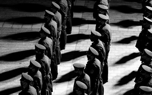 Police officers stand in rows