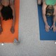 Two people practice yoga