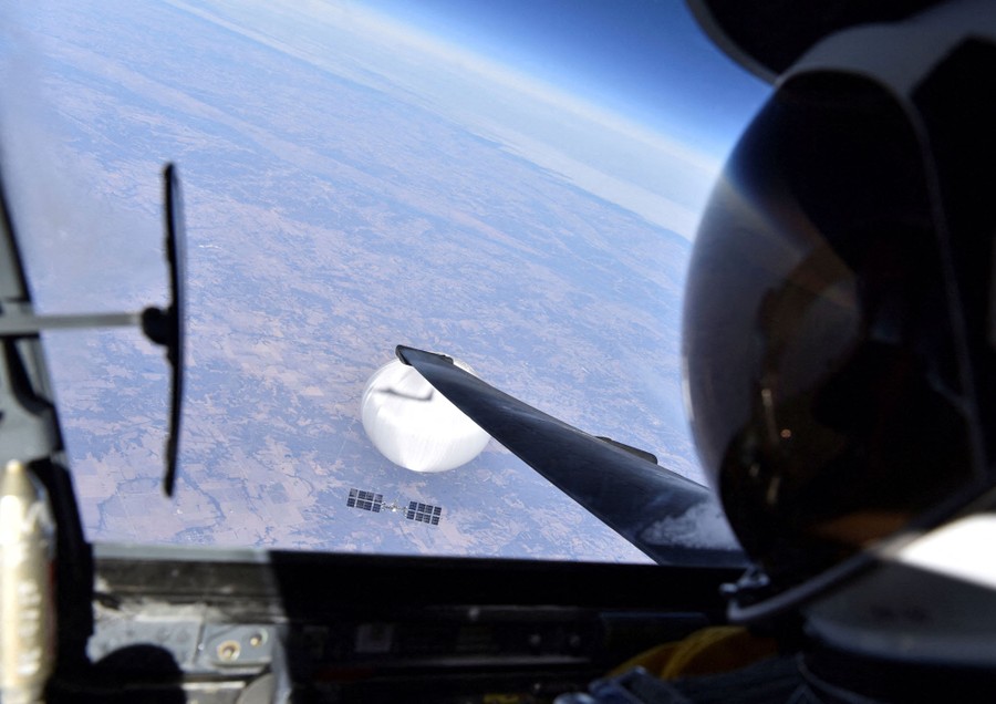 A view out the window of a U-2 spy plane, looking down at a large white balloon