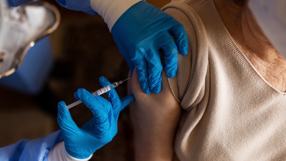 Woman getting a vaccine in her arm