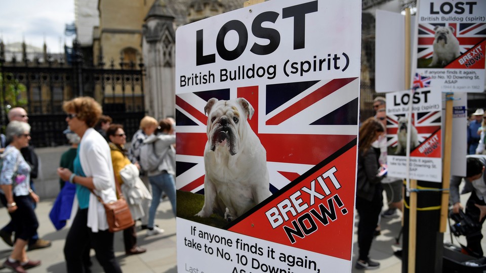 People walk past pro-Brexit placards in central London.