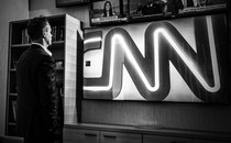 Chris Licht next to a CNN sign
