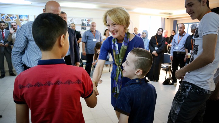 Alice Wells, the U.S. Ambassador to Jordan, greets members of the Jouriyeh family before they leave for resettlement in San Diego, California