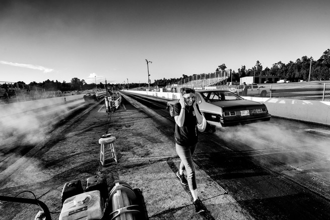 Picture of Nuwisha Williams protecting her ears from the loud engines at the Holly Springs Motorsports racetrack in Holly Springs, Miss.