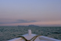 White boat pointed at a sunset