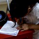 A girl writes a letter.