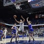 Connecticut's Napheesa Collier, center, splits Tulsa's defense during the first half of an NCAA college basketball game in the American Athletic Conference tournament quarterfinals.