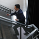 Photograph of Andrew Yang briskly walking up a staircase