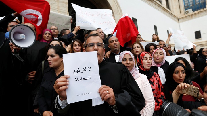Tunisian lawyers gather as they demonstrate against the government's proposed new taxes, near the courthouse, in Tunis, Tunisia October 21, 2016.