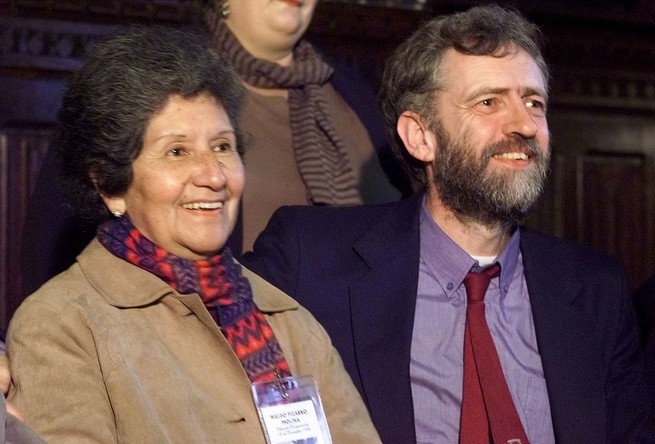 A younger Jeremy Corbyn sits alongside a woman who was a victim of Augusto Pinochet's regime.