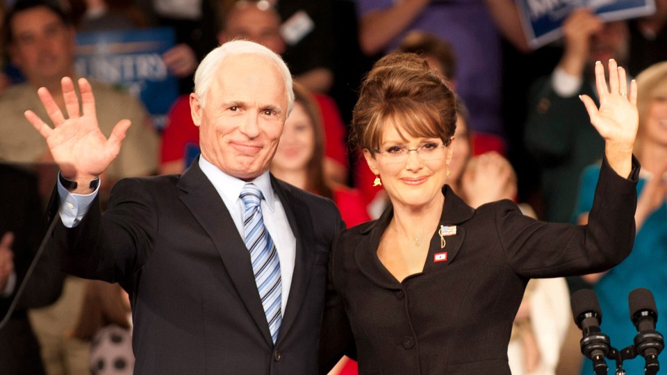 a still from the movie 'Game Change,' with a waving Ed Harris, left, as John McCain, and Julianne Moore as Sarah Palin, right