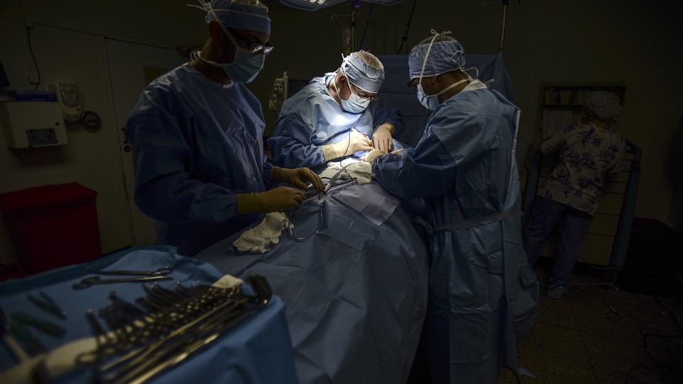 Surgeons work on a patient at Dr. Isaac Gonzalez Martínez Oncological Hospital in San Juan.