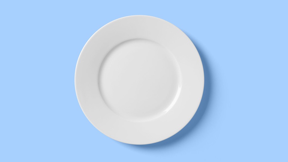 An empty white plate on a blue background