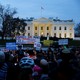 Demonstrators rally against the Trump administration's new travel ban outside of the White House.