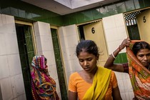 Women waiting to use a community toilet in India