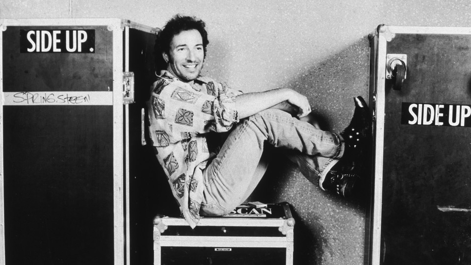 Bruce Springsteen sitting smiling