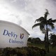 A sign reading "DeVry University" sits next to a palm tree in Florida.