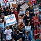 Photograph from above of a large crowd of protestors holding anti-ICE signs in Chicago