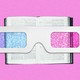 A pair of old-school 3D glasses over a book on a pink background.
