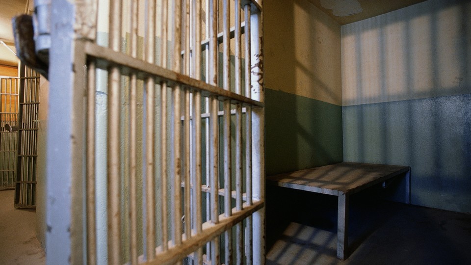 A prison cell with the door open