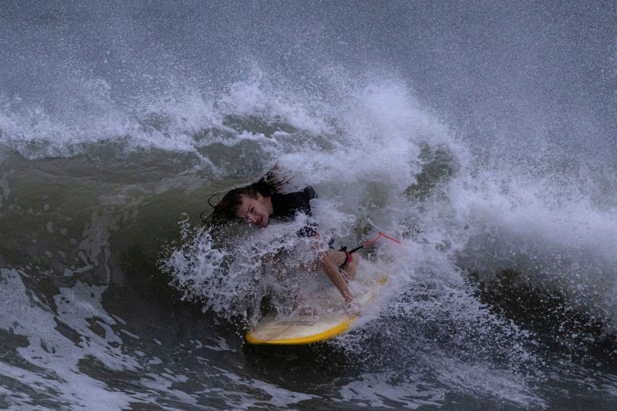 A surfer rides a chaotic wave.