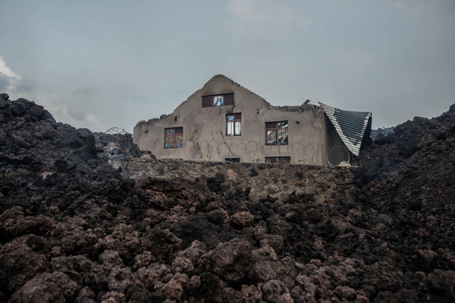 Volcanic rocks surround a house.