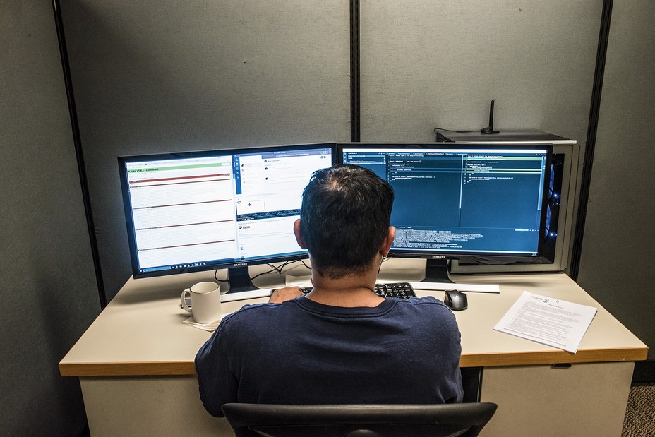 Vinson working at a desk with two monitors.