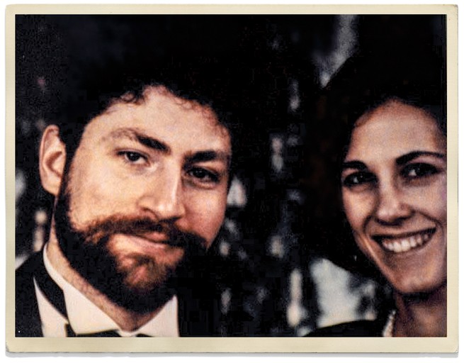 snapshot photo of bearded man in black tie with smiling dark-haired woman
