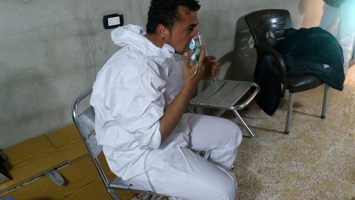 A man breathes through an oxygen mask, after what rescue workers described as a suspected gas attack in the town of Khan Sheikhoun in rebel-held Idlib, Syria, on April 4, 2017.