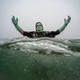 A reveler dressed as Frankenstein's monster plunges into the ocean during a polar bear plunge event.