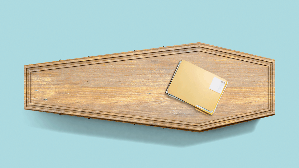 A coffin with a folder of papers on top