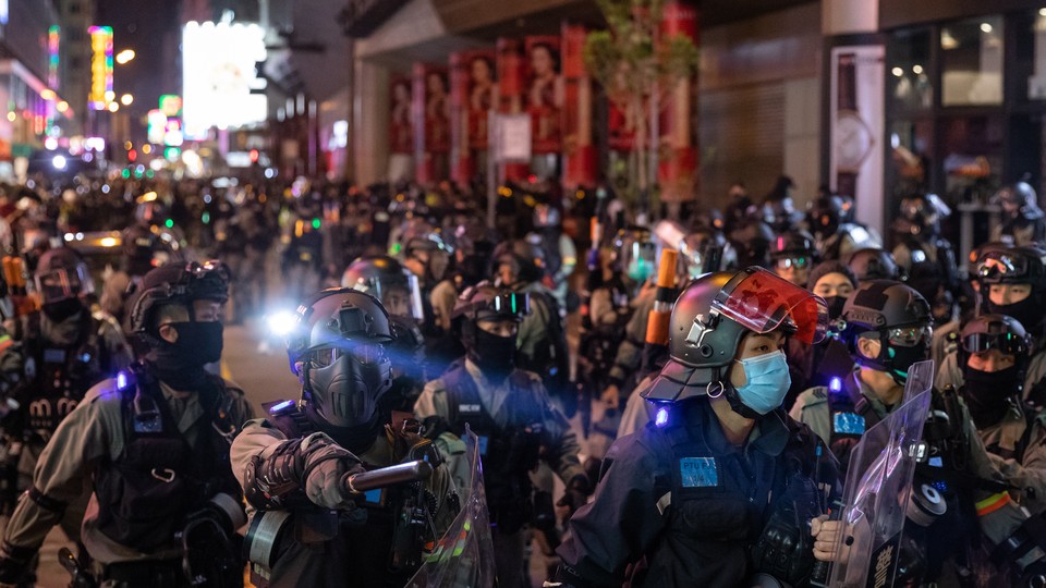 Riot police respond to demonstrators in Hong Kong protesting against a plan to use new public housing as a possible coronavirus quarantine facility.